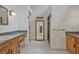 Bright bathroom features dual wooden vanities, granite countertop, and walk-in shower at 605 Ga 120 Hwy, Roswell, GA 30075