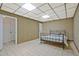 Bedroom featuring tile flooring, a drop ceiling, and a bed, providing a simple and comfortable living space at 605 Ga 120 Hwy, Roswell, GA 30075