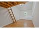 Spacious bedroom featuring wood floors, white walls, and a unique loft-style bed area with ladder access at 605 Ga 120 Hwy, Roswell, GA 30075