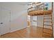 Bright bedroom with a unique loft bed and wooden ladder access, showcasing a charming and efficient use of space at 605 Ga 120 Hwy, Roswell, GA 30075