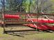Wooden rack storing red canoes, showcasing the facilities for water activities at 605 Ga 120 Hwy, Roswell, GA 30075