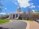 Exterior view of a City Hall, showcasing a grand entrance, manicured lawns, and ample parking spaces at 605 Ga 120 Hwy, Roswell, GA 30075
