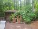 Wooden deck with potted plants and shed surrounded by lush greenery at 605 Ga 120 Hwy, Roswell, GA 30075