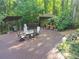 Spacious wood deck featuring outdoor seating, grill, and shed with tranquil greenery at 605 Ga 120 Hwy, Roswell, GA 30075