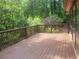 Wood deck with brown railing overlooks a lush green yard at 605 Ga 120 Hwy, Roswell, GA 30075