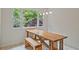 Sunny dining area with a large window offers views of the trees and unique table with an integrated bench at 605 Ga 120 Hwy, Roswell, GA 30075