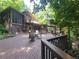 Inviting exterior showcasing a beautiful deck with outdoor seating and wooded surroundings at 605 Ga 120 Hwy, Roswell, GA 30075