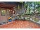 Charming front porch with brick patio, seating area, and rustic wooden siding at 605 Ga 120 Hwy, Roswell, GA 30075