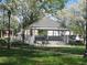 Scenic view of a gazebo featuring a grey roof, surrounded by green grass and budding trees at 605 Ga 120 Hwy, Roswell, GA 30075