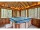 Hot tub in wood gazebo with wood slats and natural wood roof at 605 Ga 120 Hwy, Roswell, GA 30075