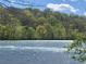 A picturesque lake view with lush green trees in the background, creating a serene atmosphere at 605 Ga 120 Hwy, Roswell, GA 30075