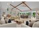 Living room with vaulted ceilings, exposed beams and large windows brings the outdoors in at 605 Ga 120 Hwy, Roswell, GA 30075