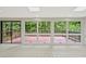 Bright living area with large windows offering views of the outdoor deck and surrounding greenery at 605 Ga 120 Hwy, Roswell, GA 30075