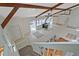 Upper view of living room showing vaulted ceilings, wood beams, stove, and tiled floor at 605 Ga 120 Hwy, Roswell, GA 30075