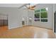 Light filled main bedroom offers vaulted ceilings, a walk-in closet and backyard view with patio access at 605 Ga 120 Hwy, Roswell, GA 30075