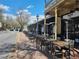 Outdoor patio seating in front of a commercial building, providing a comfortable dining experience at 605 Ga 120 Hwy, Roswell, GA 30075