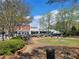 A public park with a view of multiple businesses and shops in the background at 605 Ga 120 Hwy, Roswell, GA 30075