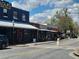 Street view of restaurants with awnings, outdoor seating, and storefronts with pedestrian access at 605 Ga 120 Hwy, Roswell, GA 30075
