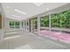 Bright sunroom with tile floors, skylights, and expansive windows showcasing the surrounding landscape at 605 Ga 120 Hwy, Roswell, GA 30075