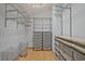 Spacious walk-in closet features custom shelving and ample storage solutions for organizing your wardrobe and accessories at 605 Ga 120 Hwy, Roswell, GA 30075