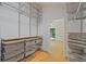 Generous walk-in closet with metal organizers offers an efficient and organized wardrobe storage solution at 605 Ga 120 Hwy, Roswell, GA 30075