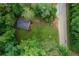 Aerial view of a property featuring manicured yard and tree coverage near a road at 2865 Chattahoochee Rd, Cumming, GA 30041
