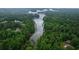 Panoramic aerial view featuring a river surrounded by a forest and various homes nearby at 2865 Chattahoochee Rd, Cumming, GA 30041