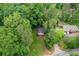 Aerial view of a property surrounded by lush greenery with surrounding properties at 2865 Chattahoochee Rd, Cumming, GA 30041