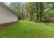 Sideyard view of home with large lawn, offering a spacious area for outdoor activities and relaxation at 2865 Chattahoochee Rd, Cumming, GA 30041