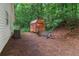 View of backyard shed alongside house, with potential storage and recreational space at 2865 Chattahoochee Rd, Cumming, GA 30041
