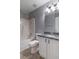 Bathroom featuring a shower-tub combo, granite countertop, and white cabinets at 2865 Chattahoochee Rd, Cumming, GA 30041