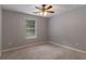 Neutral bedroom with carpeted floors, a ceiling fan, and a window allowing natural light at 2865 Chattahoochee Rd, Cumming, GA 30041