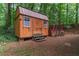 A wooden shed with a set of stairs and a baseball practice net located near the house at 2865 Chattahoochee Rd, Cumming, GA 30041