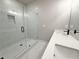 Modern bathroom featuring double sinks and a glass shower with tile walls at 5702 Urban Village Way # 2, Tucker, GA 30084