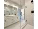 Modern bathroom with double vanity, glass shower with rainfall head, and tile surround at 5702 Urban Village Way # 2, Tucker, GA 30084