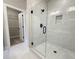 Bathroom featuring double sinks and a glass shower with tile walls and door to closet at 5702 Urban Village Way # 2, Tucker, GA 30084