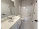 Clean bathroom featuring shower-tub combination, white vanity and white walls with black hardware at 5702 Urban Village Way # 2, Tucker, GA 30084