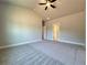 Large bedroom featuring neutral walls, carpet floors, and a ceiling fan at 5702 Urban Village Way # 2, Tucker, GA 30084