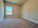 Bedroom with neutral walls, carpet flooring and natural lighting from window with backyard views at 5702 Urban Village Way # 2, Tucker, GA 30084