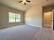 Spacious bedroom with neutral walls, large window, and carpet floors at 5702 Urban Village Way # 2, Tucker, GA 30084
