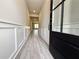 Welcoming entryway with stylish paneled walls, wood-look flooring, and ample natural light at 5702 Urban Village Way # 2, Tucker, GA 30084