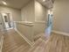 Second story hallway featuring light gray walls, white trim, and wood flooring with views to bathroom at 5702 Urban Village Way # 2, Tucker, GA 30084