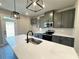 Kitchen featuring stainless steel appliances, white countertops, gray cabinets and black fixtures with backyard views at 5702 Urban Village Way # 2, Tucker, GA 30084