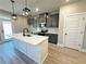 Modern kitchen features white countertops, gray cabinets and black fixtures with view to backyard access door at 5702 Urban Village Way # 2, Tucker, GA 30084