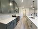 Modern kitchen featuring stainless steel appliances, white countertops, gray cabinets and black fixtures at 5702 Urban Village Way # 2, Tucker, GA 30084