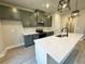 Modern kitchen featuring stainless steel appliances, white subway tile backsplash and center island with sink at 5702 Urban Village Way # 2, Tucker, GA 30084