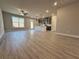 Bright living space with modern kitchen, wood-look flooring, and open-concept design at 5702 Urban Village Way # 2, Tucker, GA 30084
