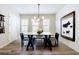 Bright dining room with modern decor, wood floors, and white walls at 6645 Cortland Walk, Alpharetta, GA 30005