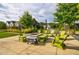 The inviting fire pit area surrounded by comfortable seating and lush landscaping is great for outdoor entertaining at 6645 Cortland Walk, Alpharetta, GA 30005