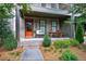 Cozy front porch with seating area and orange door at 6645 Cortland Walk, Alpharetta, GA 30005